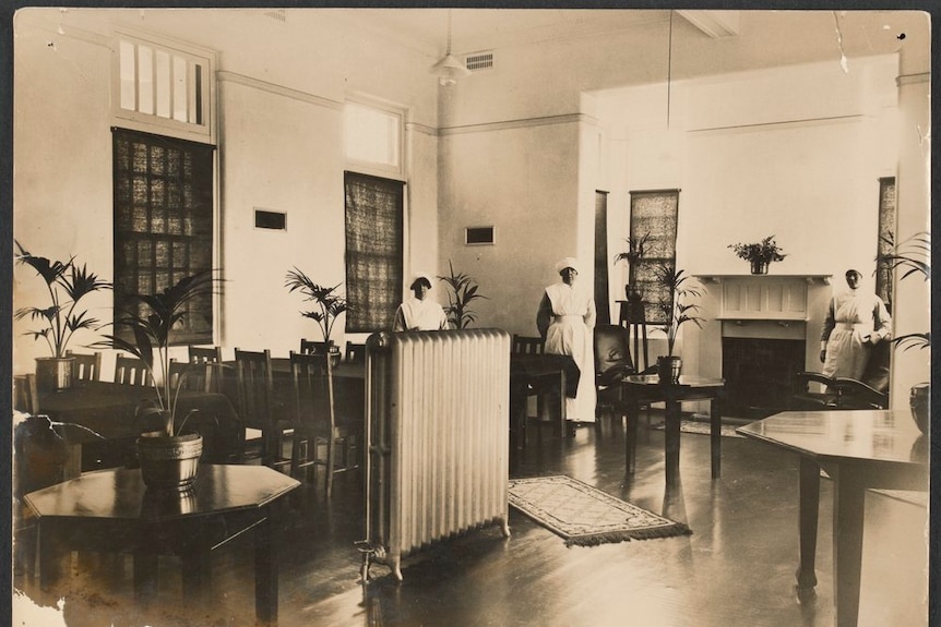 Old black and white photo of Mont Park Asylum dining room with three nurses