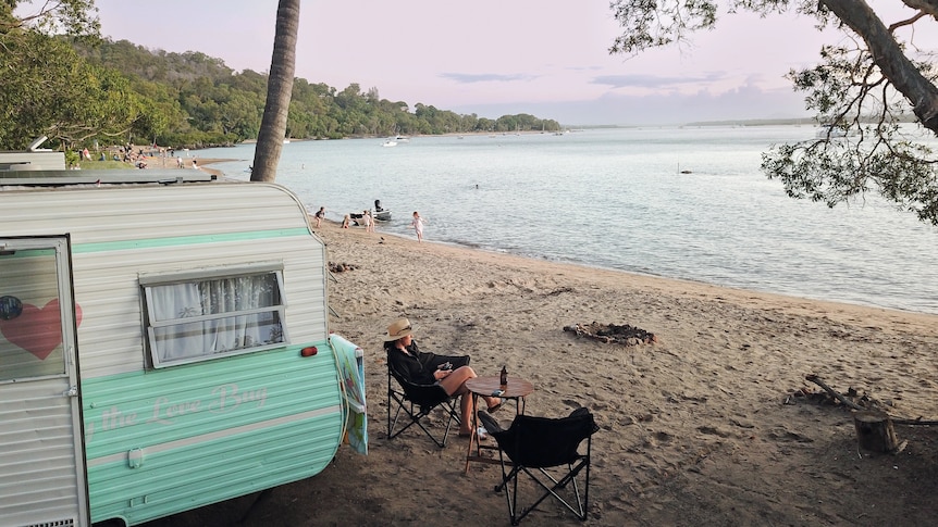 catherine best outside her caravan on the beach