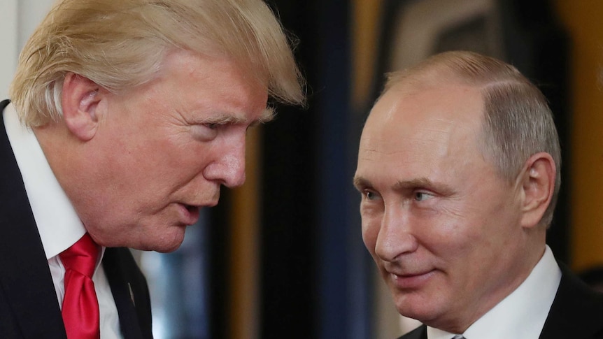 US President Donald Trump speaks to President Vladimir Putin, who is smiling.