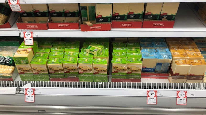 Budget homebrand cheese stacked on the shelves at Coles.