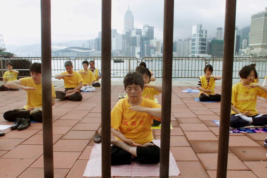 Falun Gong followers meditate in Hong Kong.