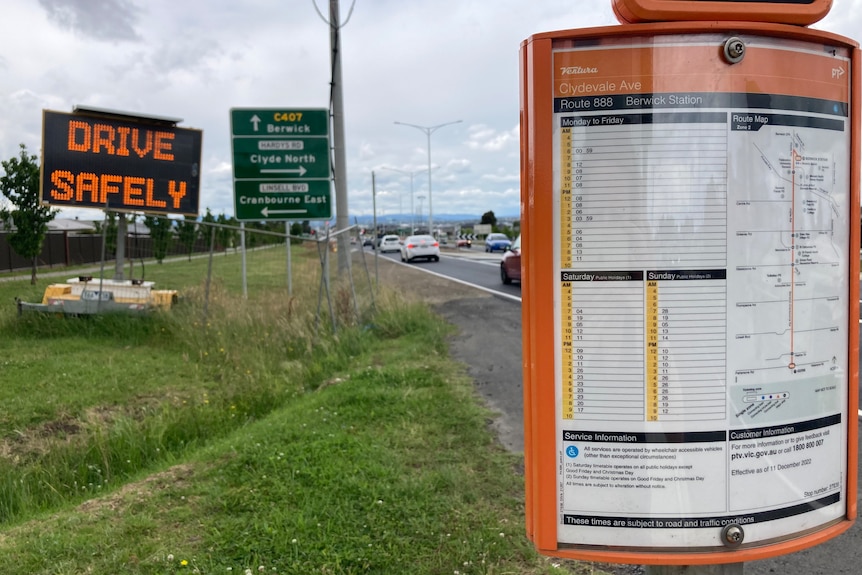 Bus timetable visible by the side of the road.