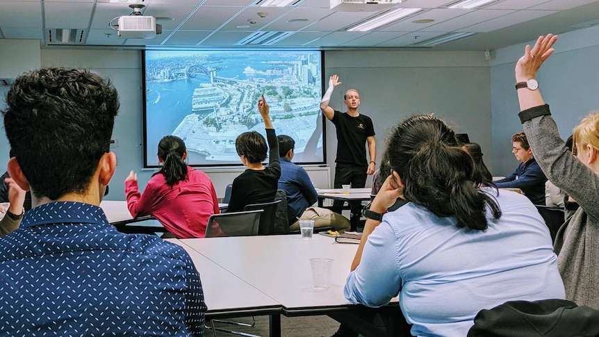 Josh Farr is a workshop with students, for a story about changing jobs during the coronavirus crisis.