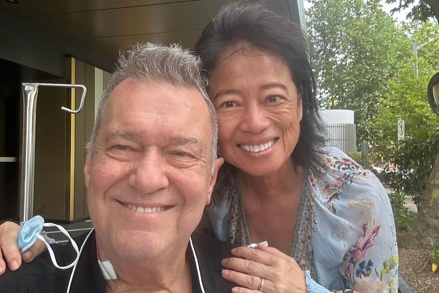 Singer Jimmy Barnes smiling with his wife asfter surgery