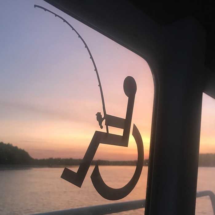 Disability wheelchair sticker with added fishing rod.