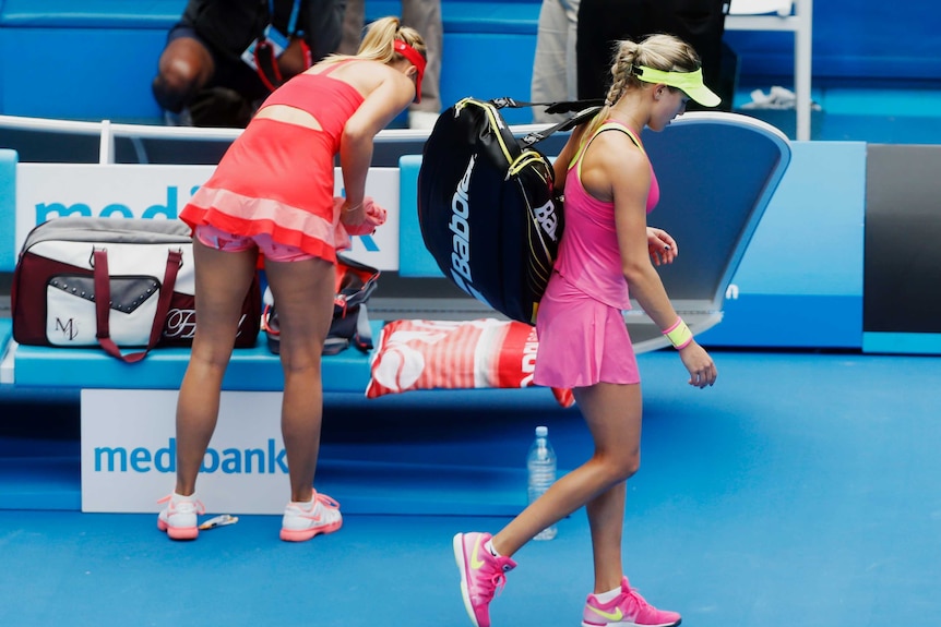 Eugenie Bouchard walks past Maria Sharapova at the Australian Open