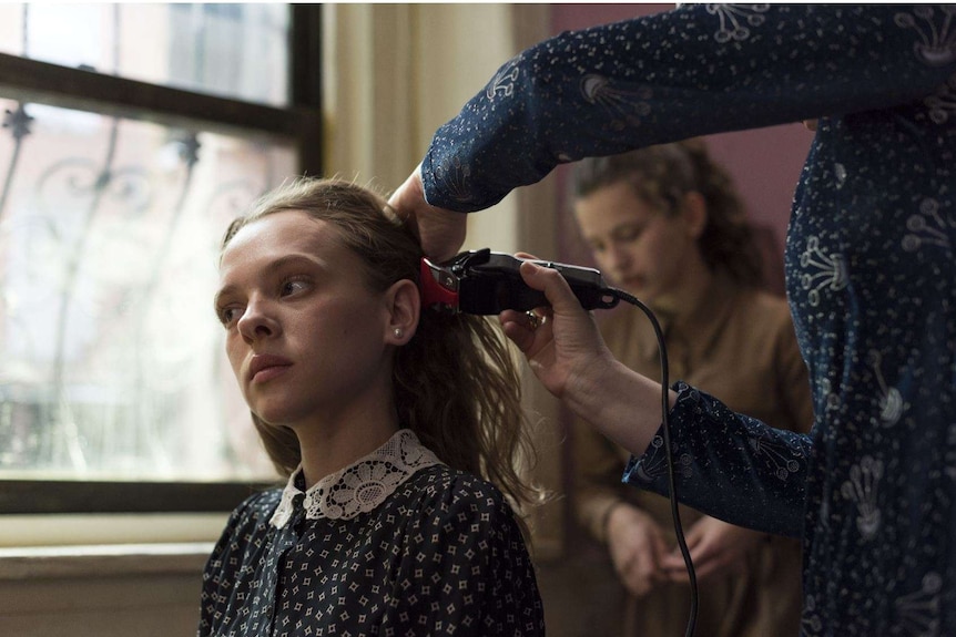 Image from the miniseries Unorthodox featuring a young Orthodox Jewish woman getting her hair shaven off