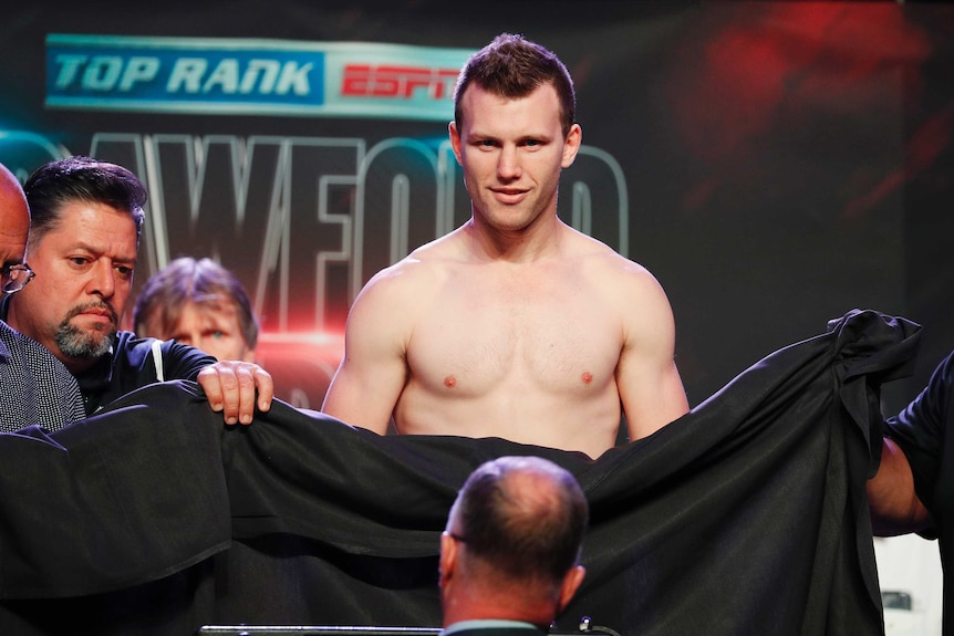 A sheet is used to cover Jeff Horn, who weighed in naked