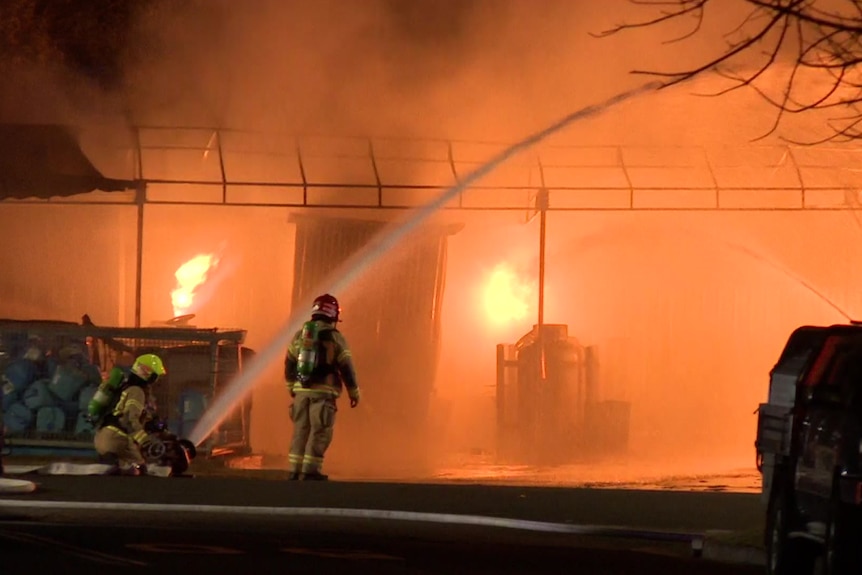 fire crews at blaze spray water on fire