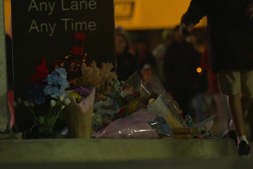 Flowers left in tribute on a curb 