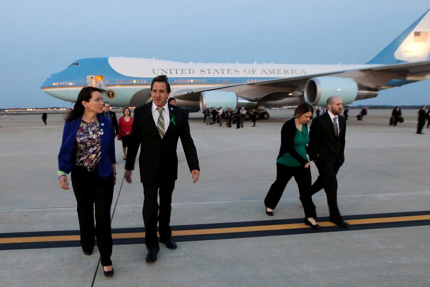 Families of victims walk from Air Force One.