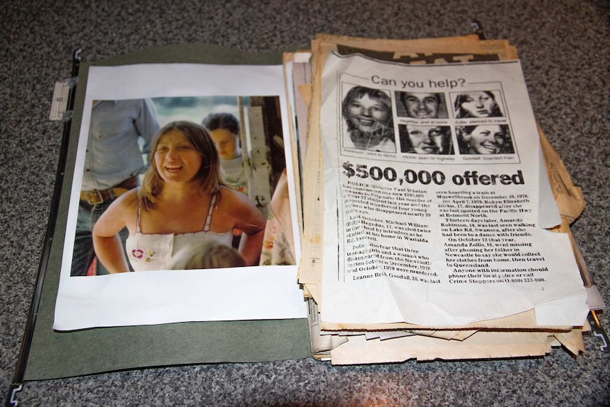 An old photo of a young woman and newspaper cuttings offering a reward for information.