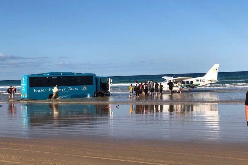A bus became bogged on a beach while attempting to rescue a stranded plane on Fraser Island on July 25, 2018.