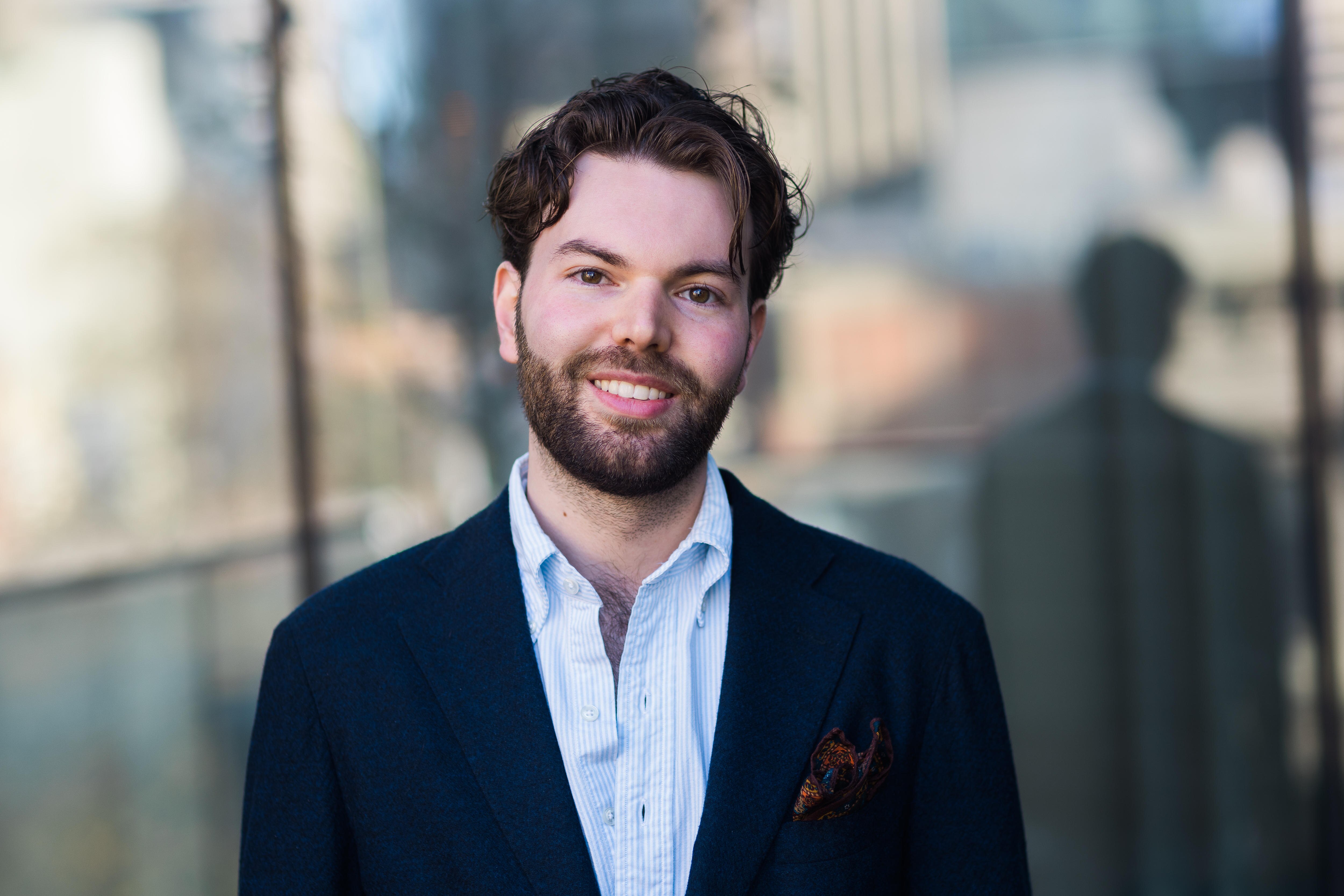 Man smiling, wearing a suit jacket