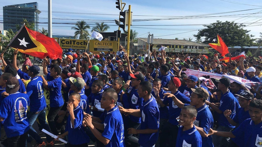 Protesters gather, wave flags outside Australian embassy in Dili