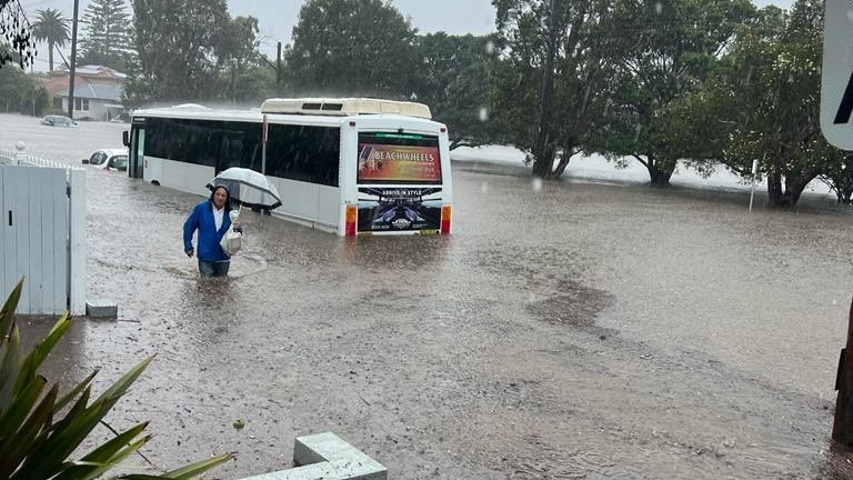 man walking in flood water