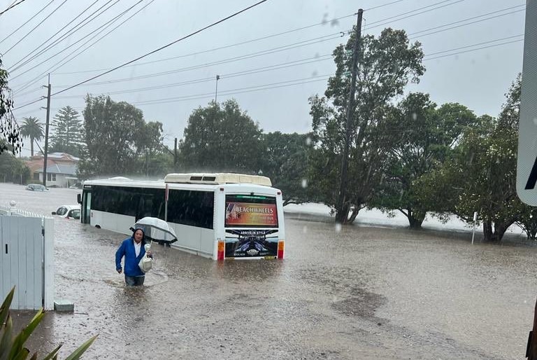 man walking in flood water