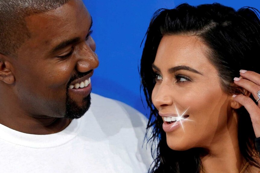 Kanye West looks at wife Kim Kardashian West