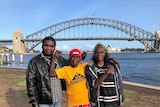 The three stand by the Sydney Harbour Bridge