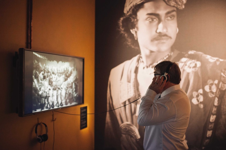 A man watches a film at the opening of the Bombay Talkies exhibition in Melbourne, 2017