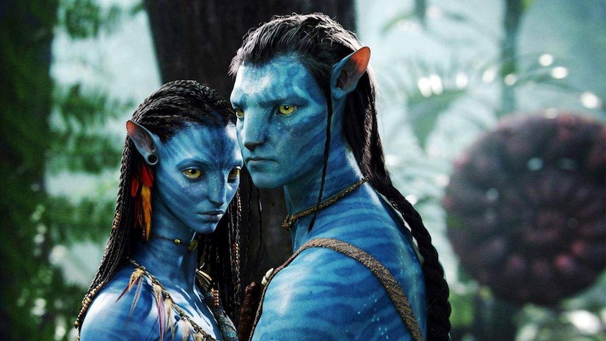 A scene from Avatar showing two human-like blue people standing near each other.