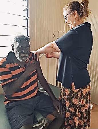 Nurse Stacey Niarchos injects an Aboriginal man with the coronavirus vaccine in a remote community in the Northern Territory. 