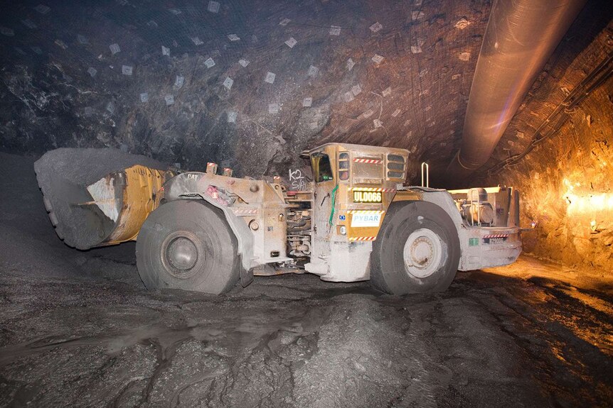 A loader machine in a mining tunnel.