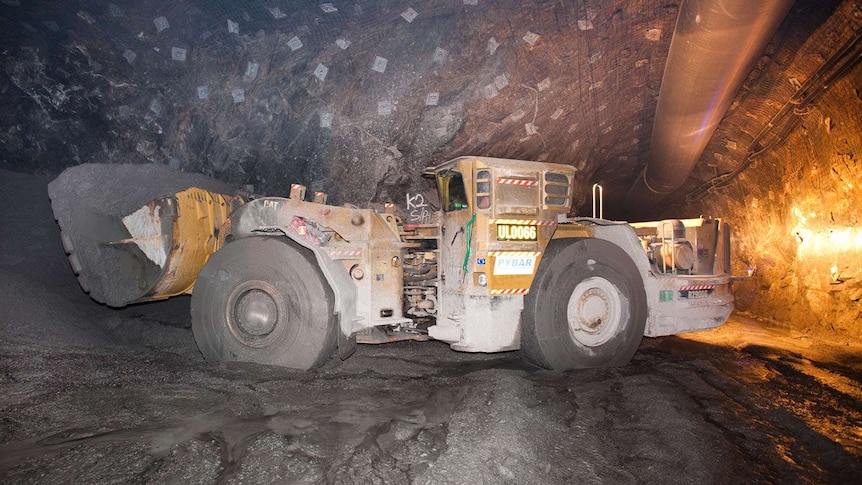 A loader machine in a mining tunnel.