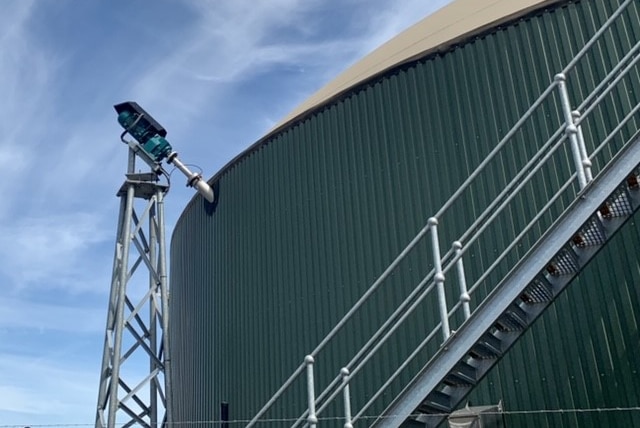 A giant tank with a mechanical arm poking in the side to mix the food waste within.