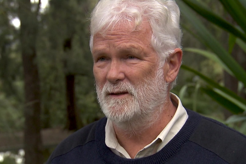 Photo of an older man talking.