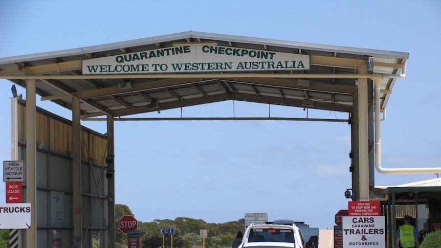 Cars travel through the quarantine checkpoint on the WA-SA border.
