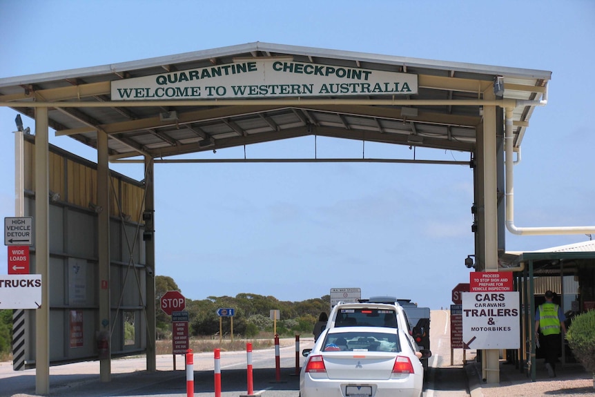 Cars travel through the quarantine checkpoint on the WA-SA border.