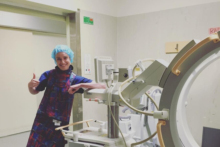 Rachel Jones with an X-ray machine, she's someone who found job satisfaction after a drastic career change.