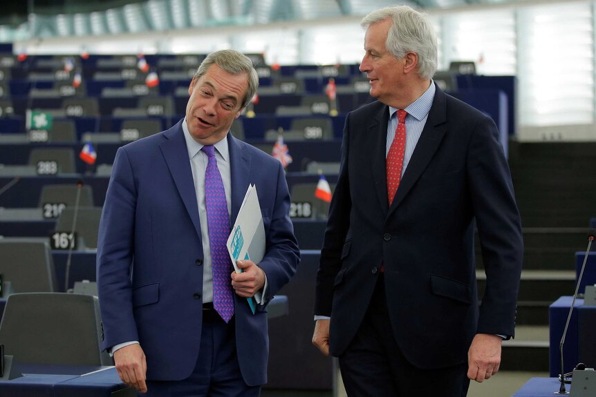 EU Brexit negotiator Michel Barnier talks with Nigel Farage at the European Parliament.