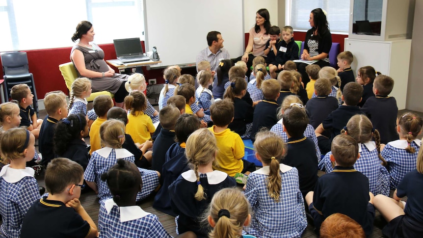 New kindergarten students listen intently to teachers at at Fraser Primary School in Canberra.