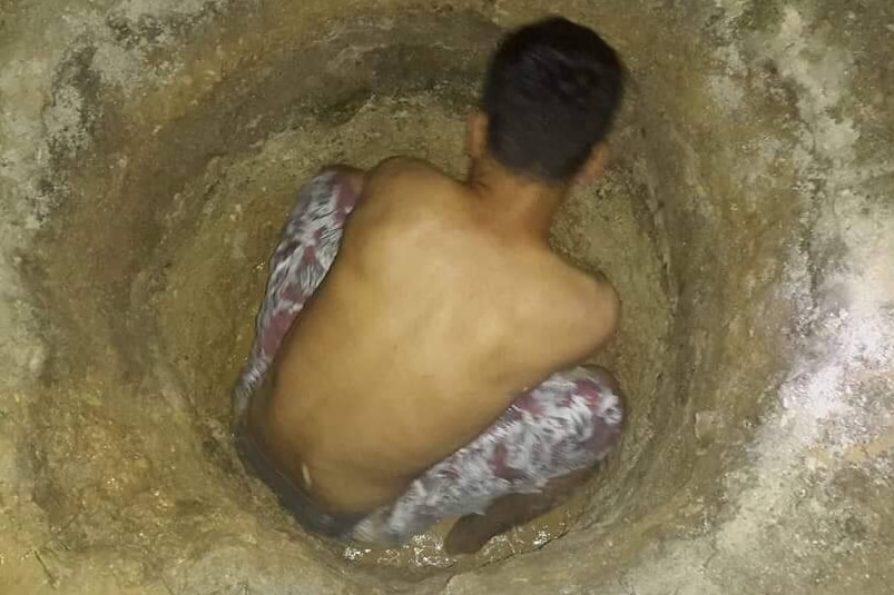 An asylum seeker on Manus Island digging in the hope of finding water.