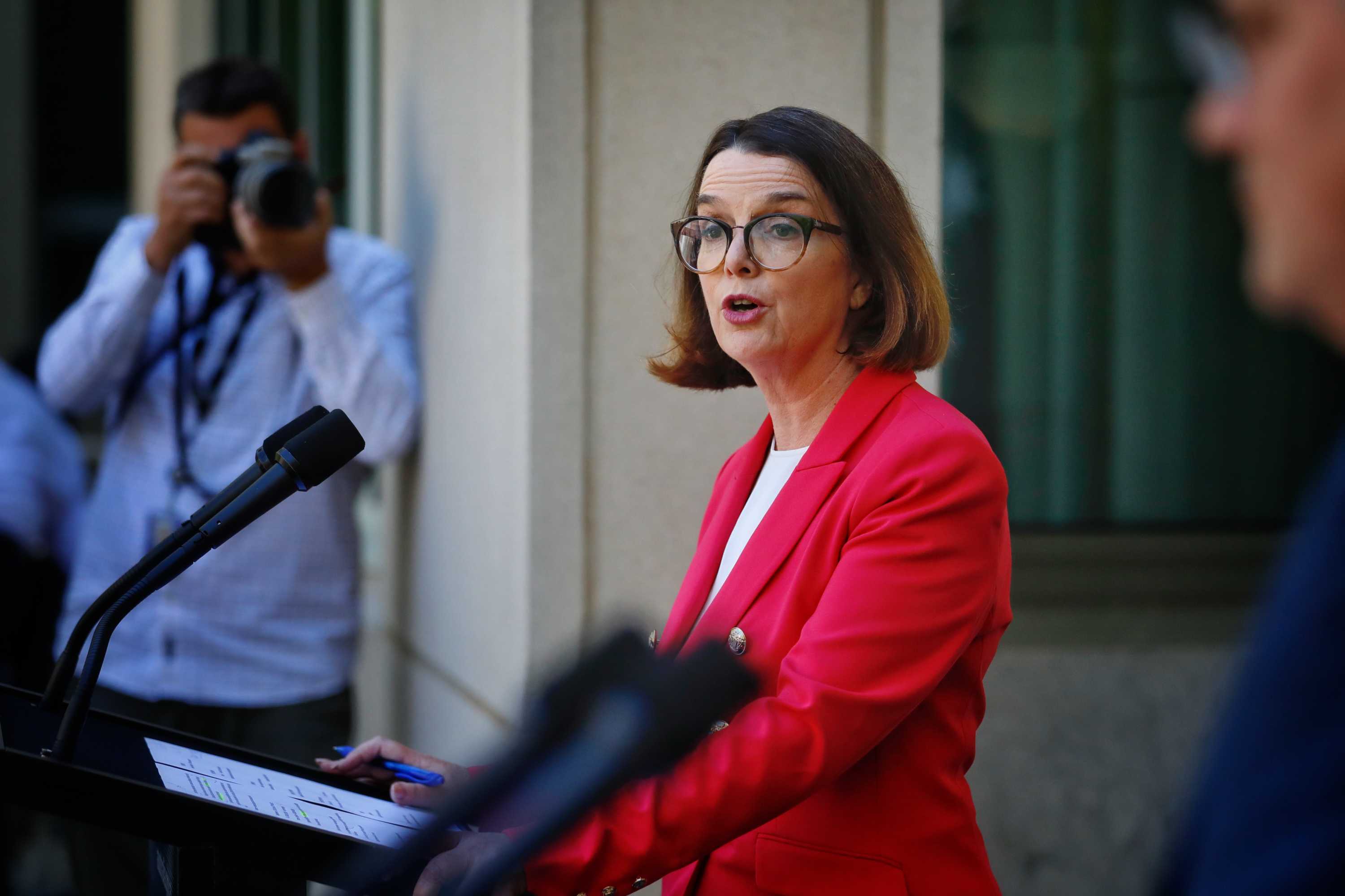 Anne Ruston addresses the media at a lectern in a courtyard