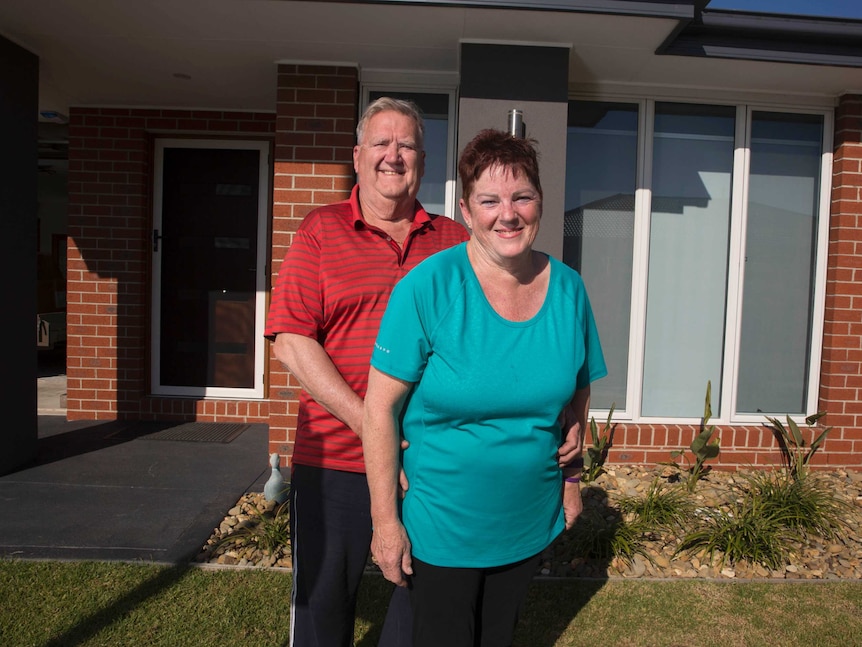 Alan Bolten and Maureen Ansell at the front of their home