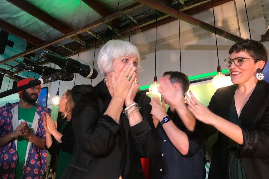 Elizabeth Watson-Brown puts hands to face the moment she found out she won the seat of Ryan for the Greens