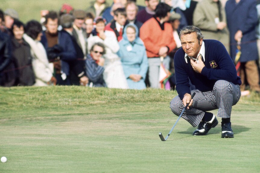 Arnold Palmer of the United States lines up a putt.