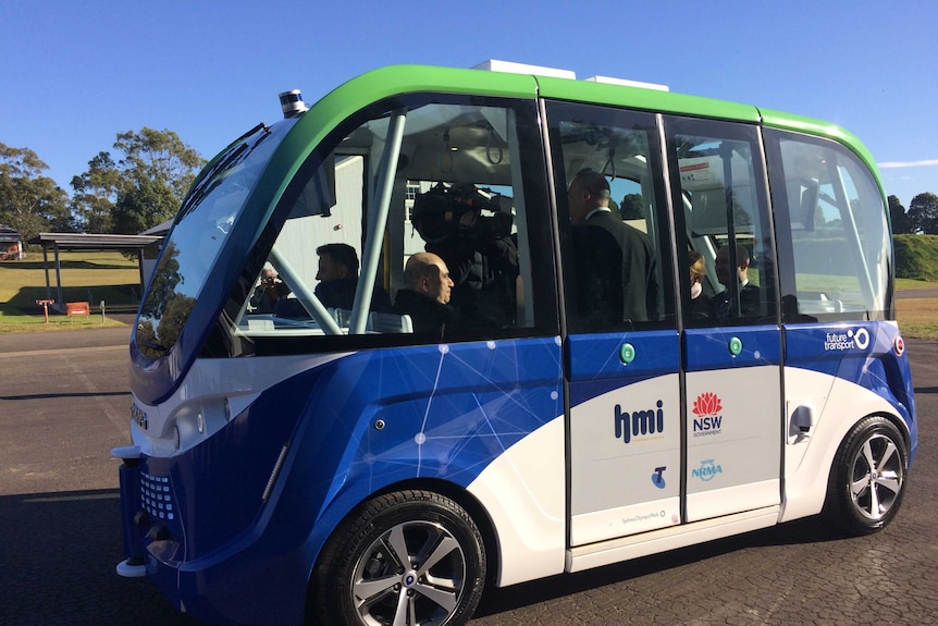 NSW ministers and media inside a small driverless car