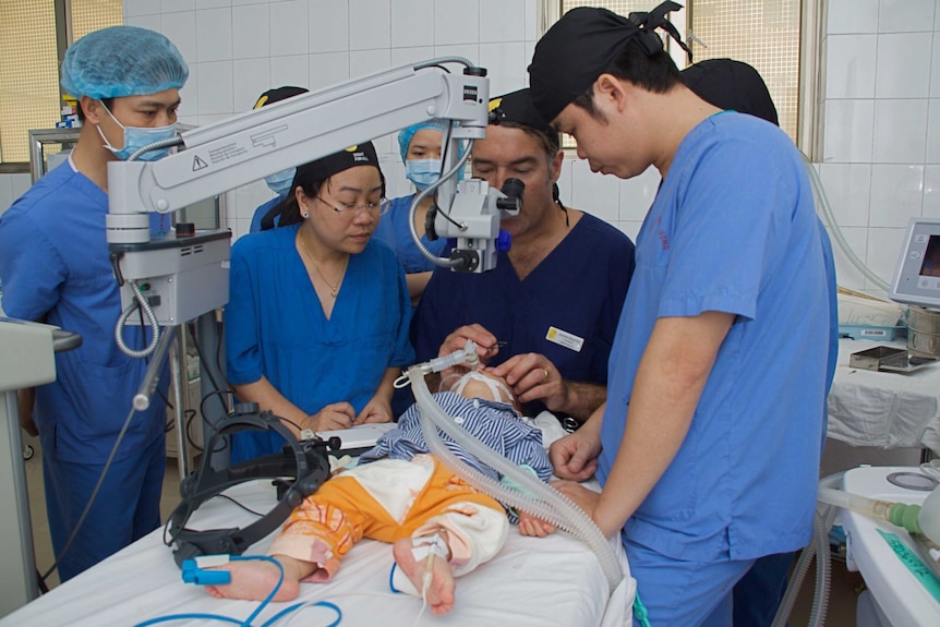 James Muecke does surgery on a child's eye.