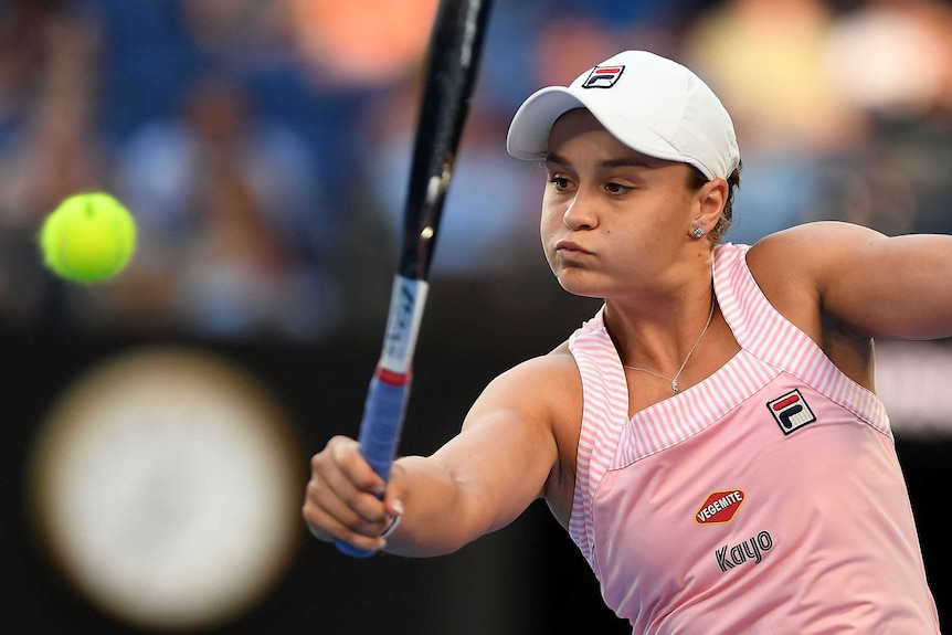 Ashleigh Barty plays a backhand return against Petra Kvitova.