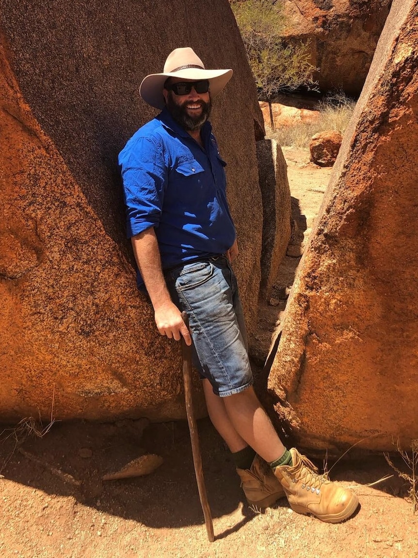 A photo of Alice Springs tour operator Mark Coulton posing at Devils Marbles.