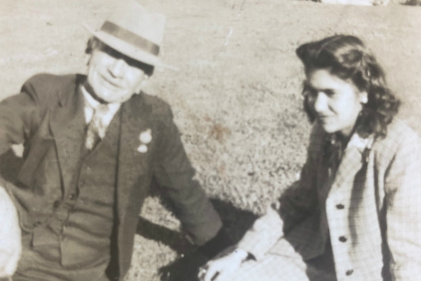 Percy Pepper sits on a lawn with his daughter, later in his life.
