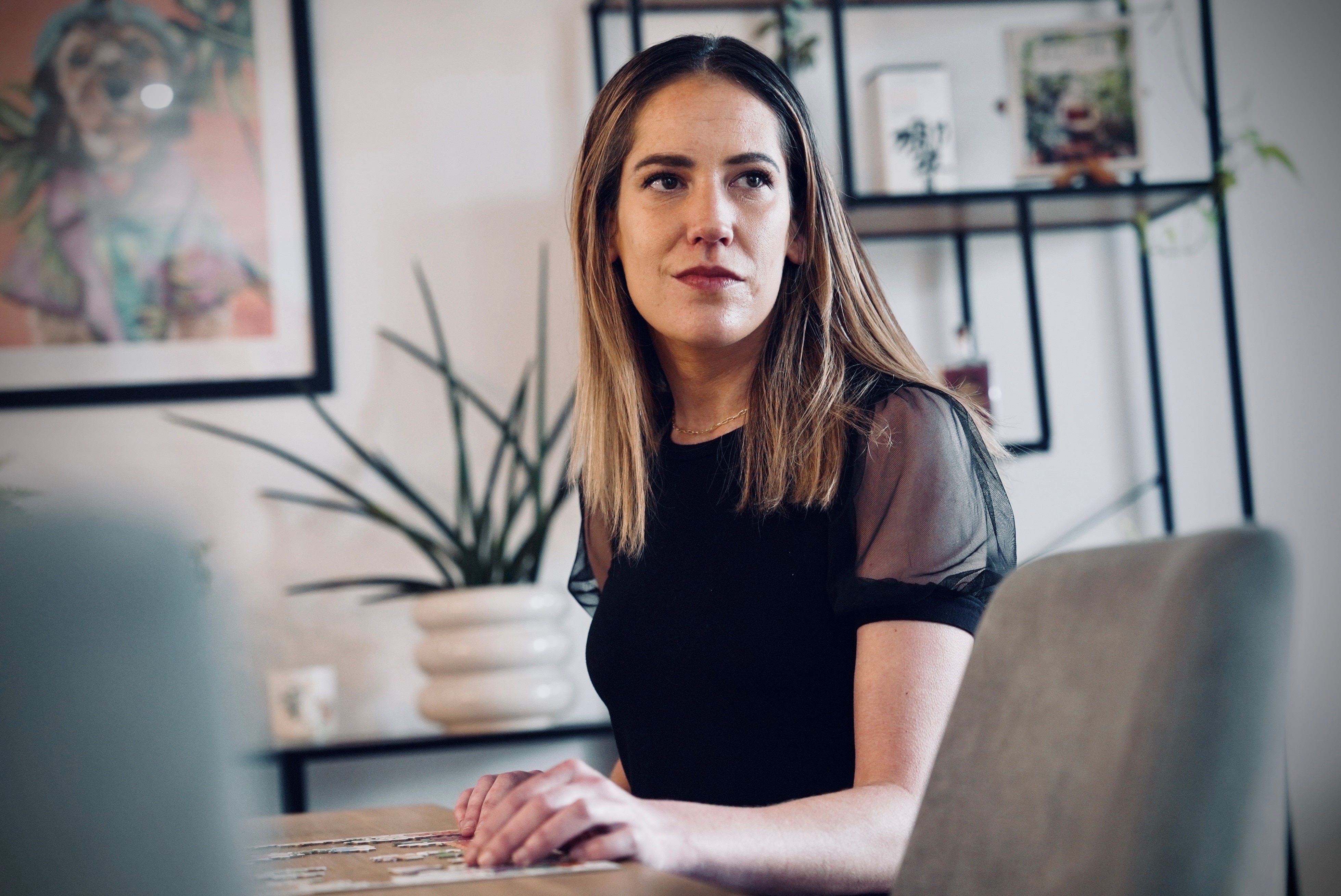 Brigid Malone sits at a desk
