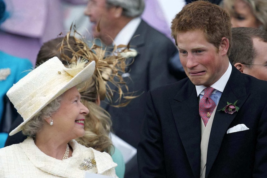 Queen Elizabeth II smiles as Prince Harry pulls a face.