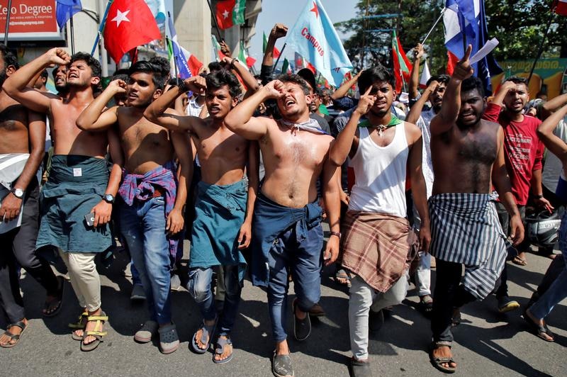 Demonstrators shout slogans and wave flags.