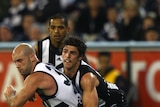 Clash of the titans... Scott Pendlebury, seen here tackling Geelong's Paul Chapman, admits the Pies are jealous of their foes