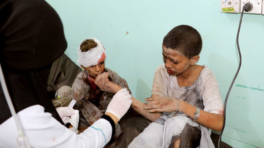 Doctors treat injured children after Saudi-led air strikes hit Yemen.